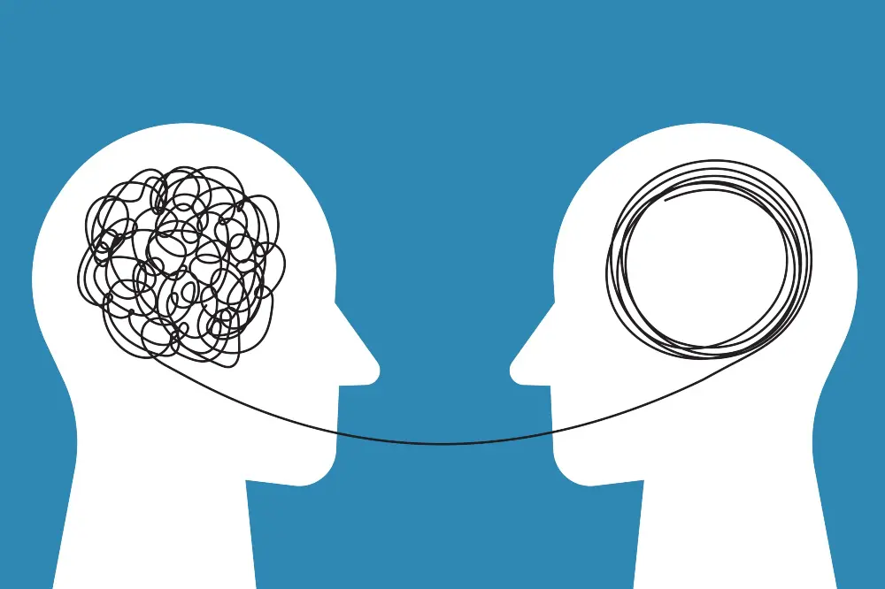 Illustrazione di due profili umani collegati da connessioni cerebrali, simbolo dell’empatia, della comprensione reciproca e della connessione emotiva nel coaching